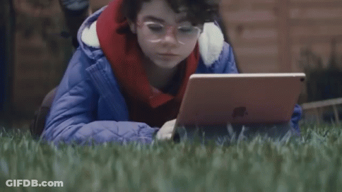Person Laying In Grass With Laptop Saying Whats A Computer GIF