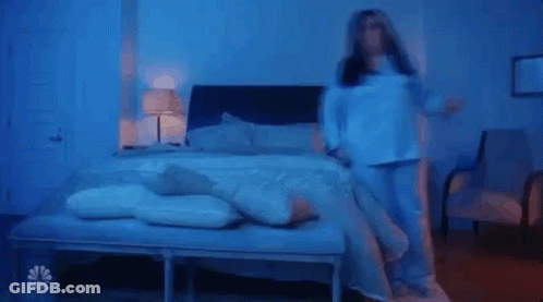 Person Laying On Bed In Blue Light GIF