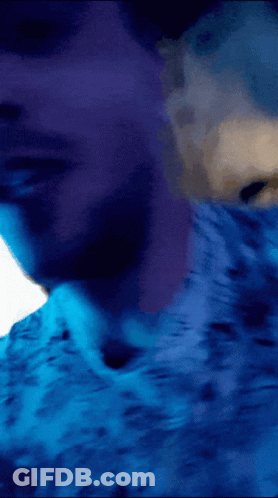 Person Laying On Bed With Blue Sheets GIF