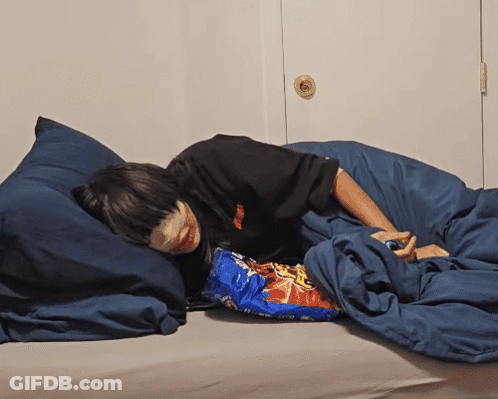 Person Laying On Bed With Doritos Bag GIF