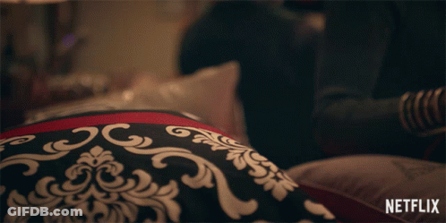 Person Laying On Bed With Netflix Logo GIF