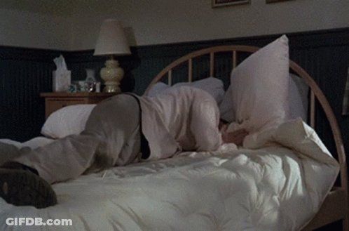 Person Laying On Bed With Pillow On Face GIF