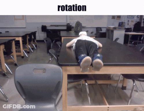 Person Laying On Classroom Table Saying Rotation GIF