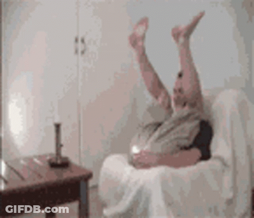 Person Laying On Couch With Legs In Air GIF