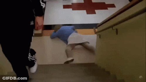 Person Laying On Floor In Front Of Red Cross GIF