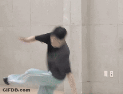 Person Laying On Green Mat With Chinese Writing GIF