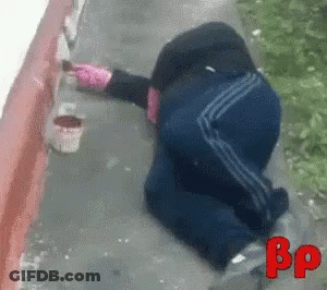 Person Laying On Ground Painting Wall With BP GIF