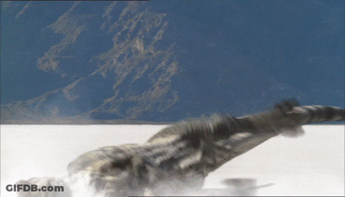 Person Laying On Snowy Surface With Mountains GIF