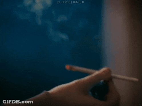 Person Lighting Cigarette With Lighter GIF