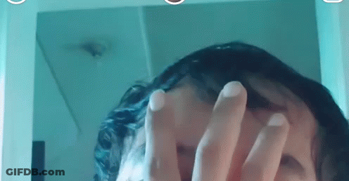 Person Looking In Mirror Covering Face With Hands GIF