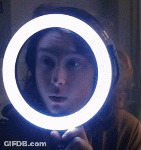 Person Looking In Mirror With Ring Light GIF