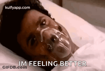 Person Lying In Hospital Bed With Oxygen Mask GIF