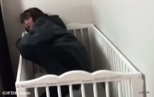 Person Lying In White Crib With SPM GIF