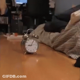 Person Lying Near Alarm Clock GIF