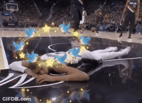 Person Lying On Basketball Court With Birds And Stars GIF