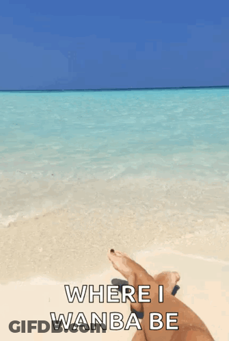 Person Lying On Beach Feet In Water GIF