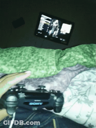 Person Lying On Bed Playing Video Game With Sony Controller GIF