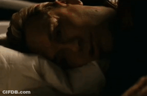 Person Lying On Bed With American Flag Blanket GIF