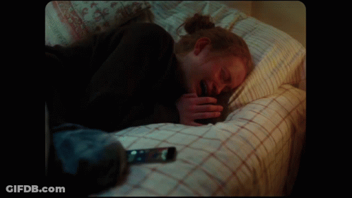Person Lying On Bed With Cell Phone GIF