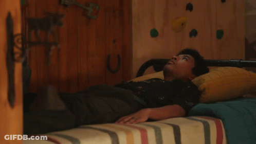 Person Lying On Bed With Horseshoe GIF