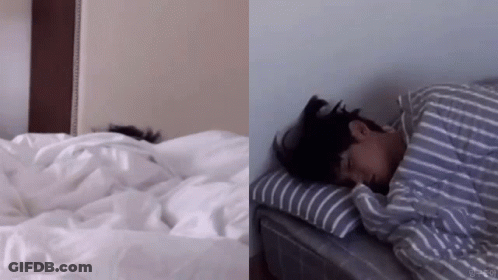 Person Lying On Bed With Striped Comforter GIF