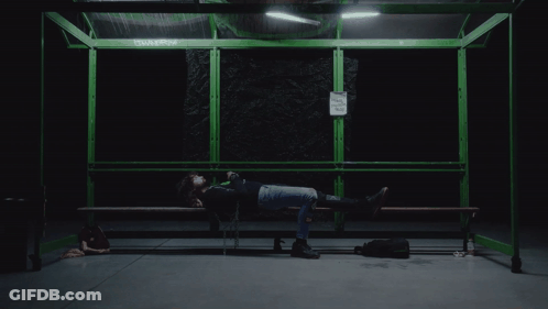 Person Lying On Bench Near No Smoking Sign GIF