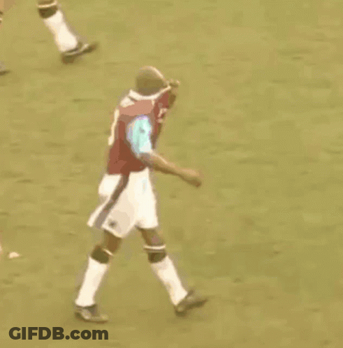 Person Lying On Soccer Field As Player Runs GIF