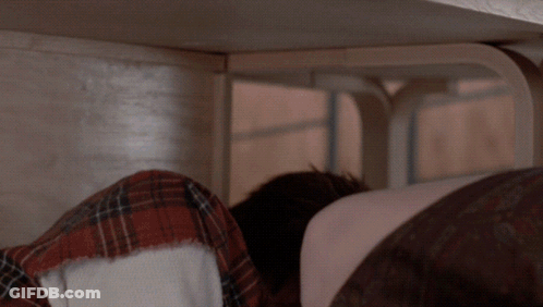 Person Lying Under Table With Head Down GIF