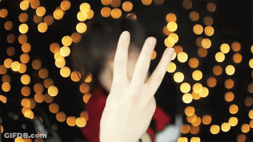 Person Making Peace Sign GIF