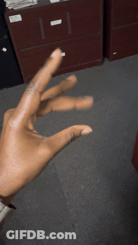 Person Making Triangle Hand Gesture GIF
