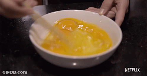 Person Mixing Eggs In Bowl With Netflix Logo GIF