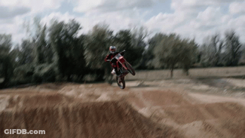 Person On Dirt Bike Jumping Over Hill GIF