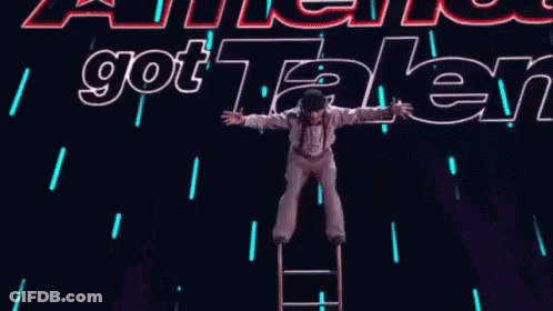 Person On Ladder In Front Of Got Talent Sign GIF