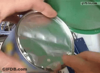 Person Opening Can With Magnifying Glass Gifbin GIF