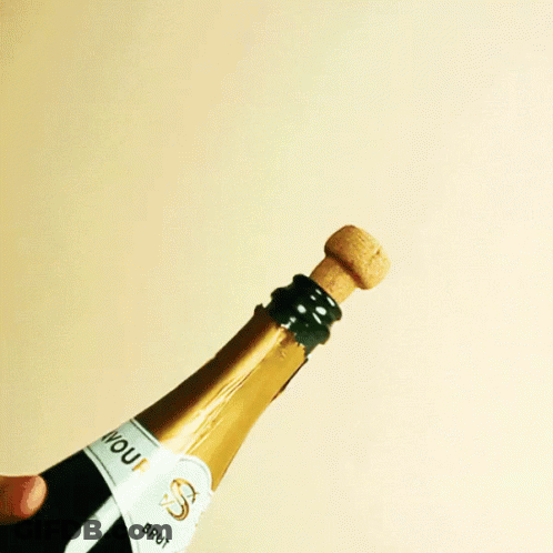 Person Opening Champagne Bottle Labeled JD GIF
