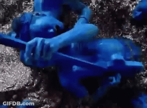 Person Painted Blue Laying On Ground GIF