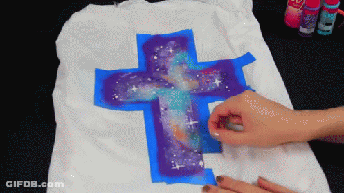 Person Painting Cross With Galaxy Design GIF