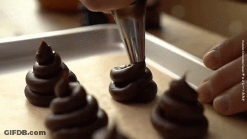 Person Piping Chocolate Cookies GIF