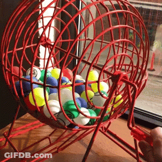 Person Playing Bingo With Red Cage Of Balls GIF