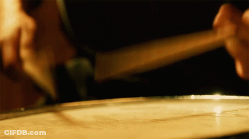 Person Playing Drum With Stick GIF