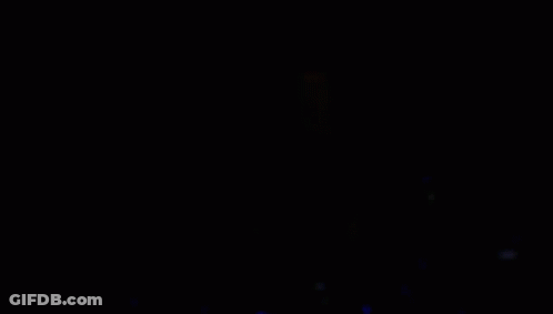Person Playing Drums In Dark Room With Cross GIF
