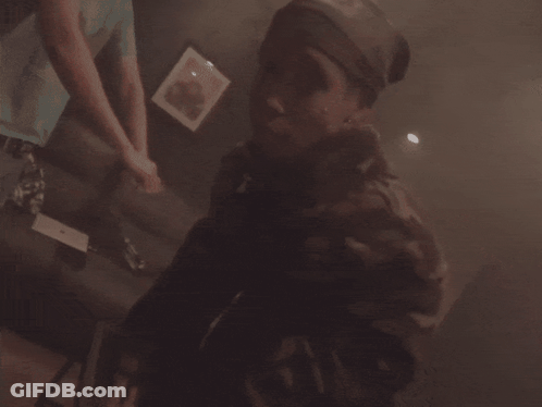 Person Playing Video Game In Dark Room With Purple Lights GIF