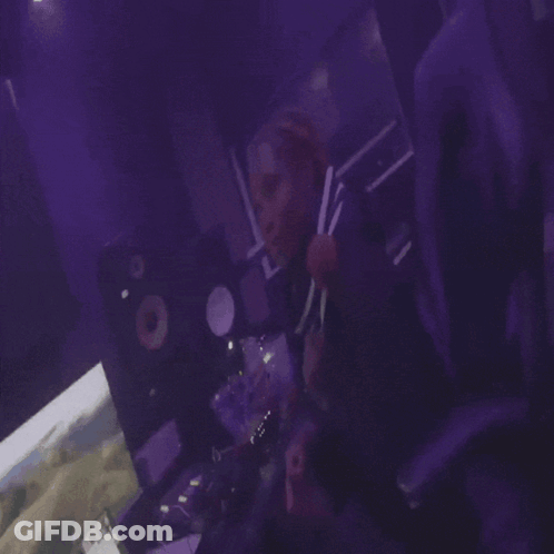 Person Playing Video Game In Dark Room With Purple Lights GIF