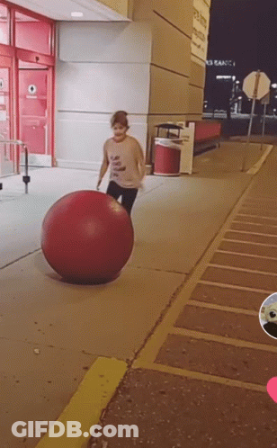 Person Playing With Large Red Ball GIF