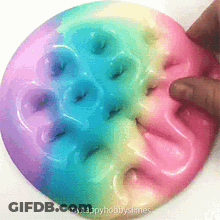 Person Playing With Rainbow Slime Donut GIF