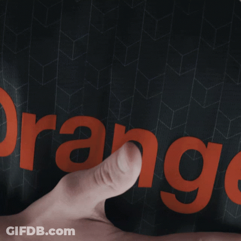 Person Pointing At Orange On Black Shirt GIF