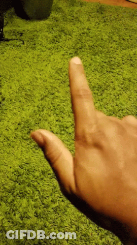 Person Pointing Thumb At Green Carpet GIF