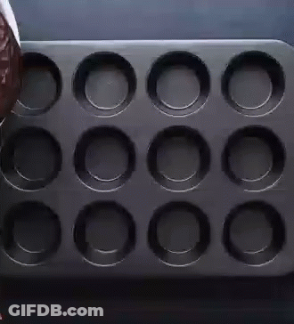 Person Pouring Chocolate Into Cupcake Pan GIF