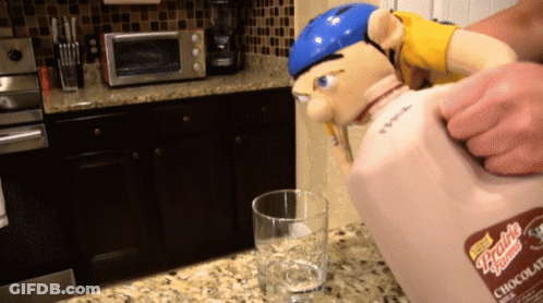 Person Pouring Chocolate Milk From Pitcher GIF