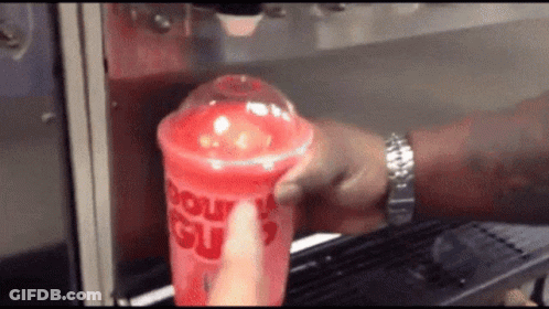 Person Pouring Drink Into Cup Saying Donut Slush GIF